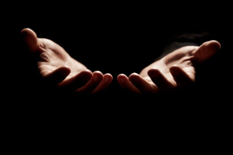 open hands to receive God's word with dark background